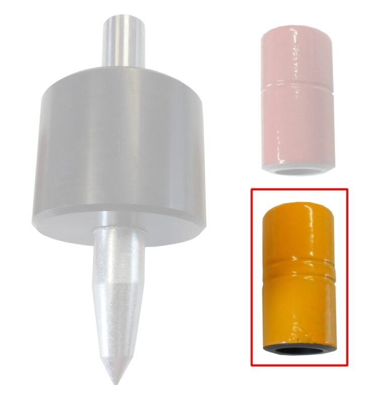 Een close-up van een grijs gereedschap met een puntige tip en twee stootbussen ernaast, een roze en een gele. De gele Fux slaghuls is rood omkaderd.