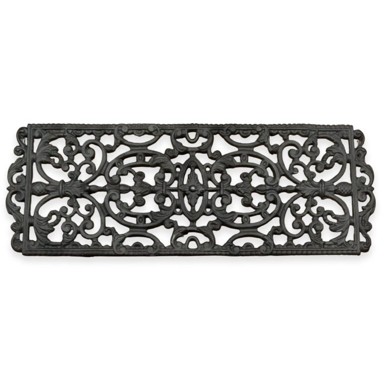Zicht op een langwerpig zwart gietijzeren rooster met sierlijke bloemen- en krulpatronen, tegen een witte achtergrond.